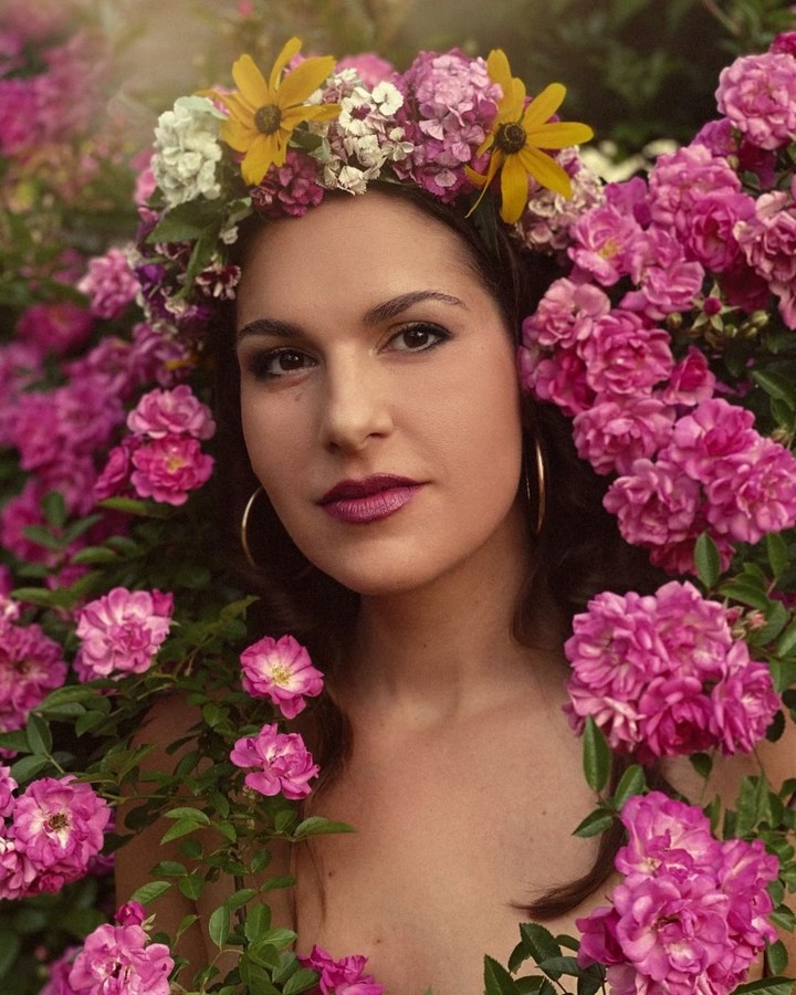 Rachael Riley wearing a flower crown among pink flowers